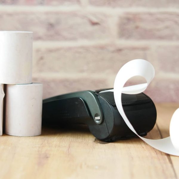 POS machine and long roll paper on table